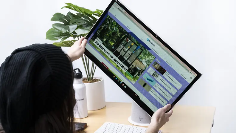 Person rotates the display on the computer