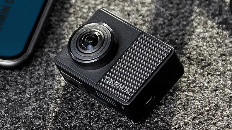 A Garmin 67W dash cam sits on a grey background