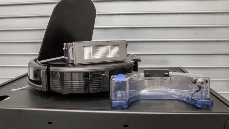 The bin on the left holds debris, while the one of the right holds water for the mop.