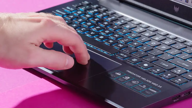 a hand inching toward the keyboard on the Acer Predator Helios Neo 14 laptop