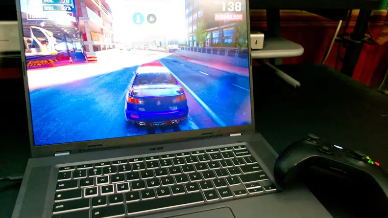 An open and powered on laptop showing a scene from a video game