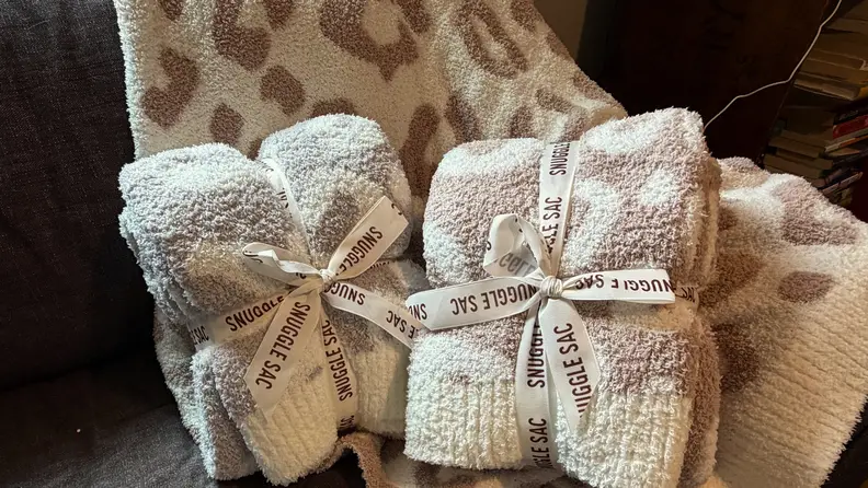 Two wrapped up blankets on a couch