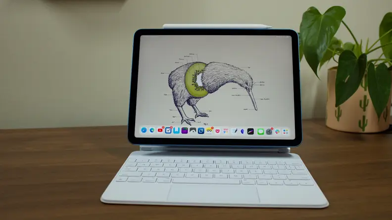 Apple's Magic Keyboard, in white, with an iPad Air attached to it.