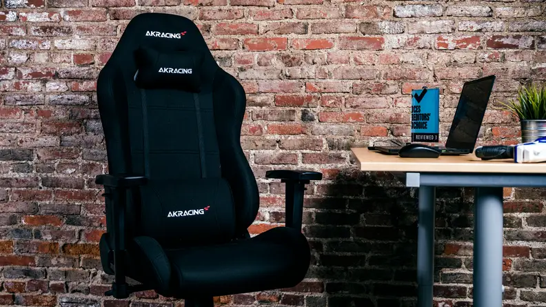 Our top pick for the best gaming chair, the black fabric akracing core EX, against a brick wall