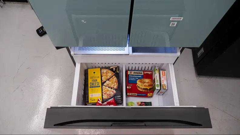 Overhead view of the bottom freezer stocked with frozen meals.