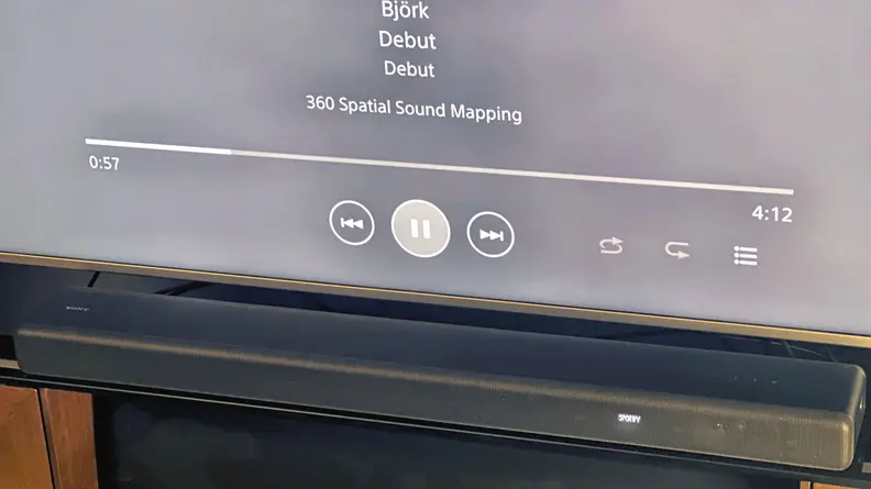 Sony HT-A3000 soundbar in front of smart television playing music.