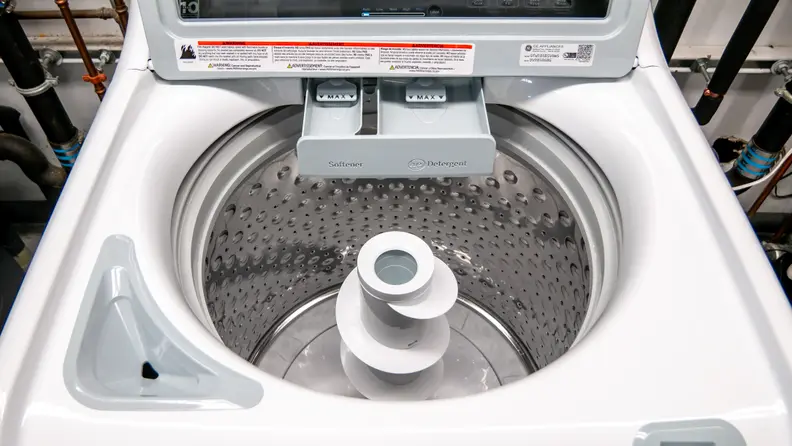 A close-up shot of the shiny silver internal drum on the GE GTW585BSVWS washing machine.