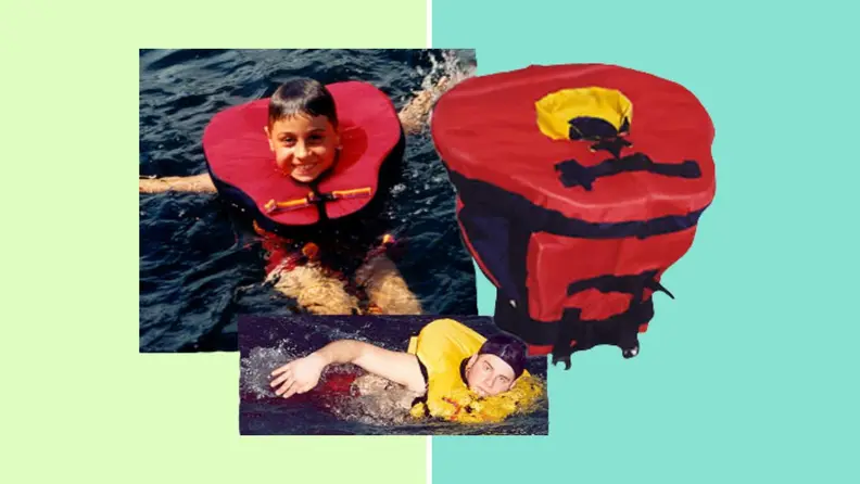 Picture of a boy and a man wearing the life jacket in the water in front of a background.