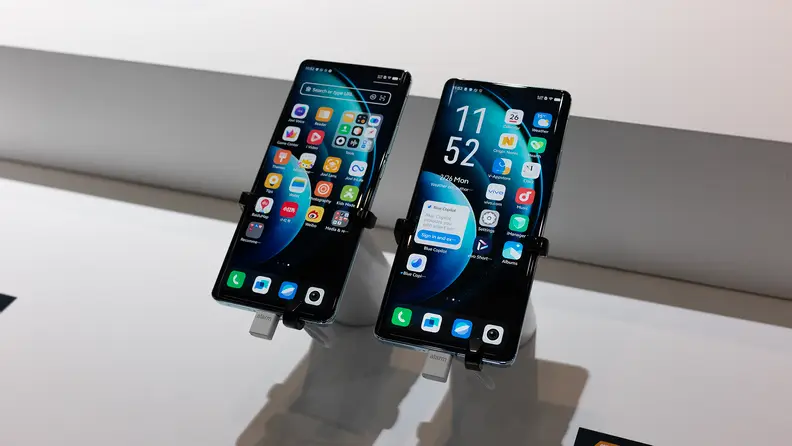 Two Vivo X100 phones sitting on displays at MWC 2024.