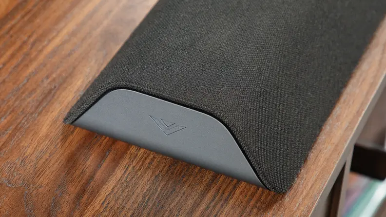 A close-in image of one end of a Vizio M-Series All-in-One M213AD-K8 Dolby Atmos Soundbar.