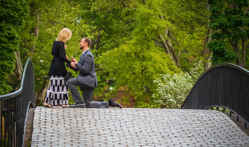 Man proposing on bridge