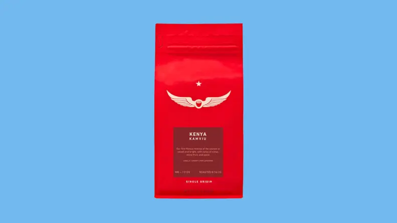 Bag of coffee beans against blue background