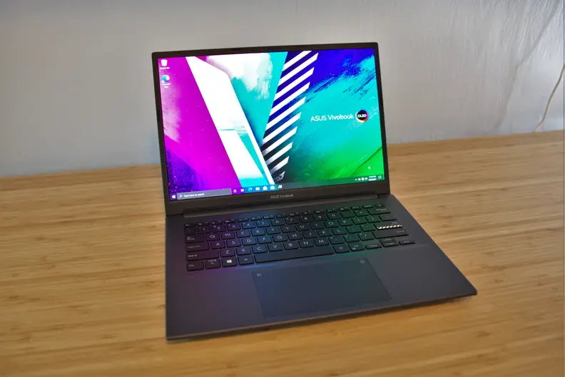 An open laptop sits on top of a desk