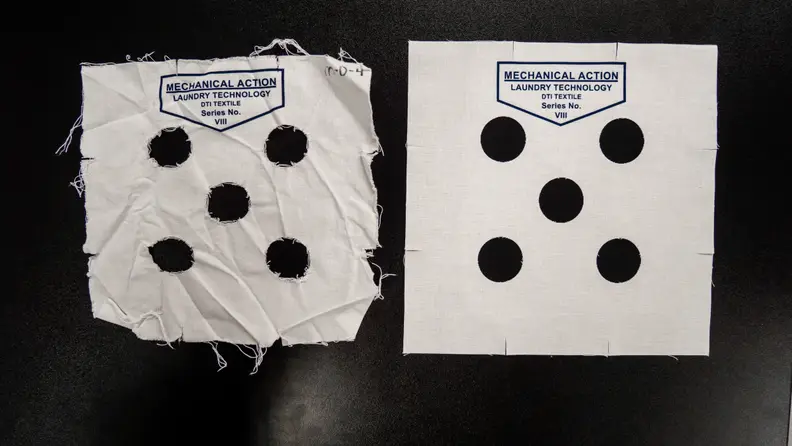 Two strips are laid out with 5 holes cut in the center of each, resembling the face of playing dice. On one side the strip looks cleanly cut. This is before a wash cycle. The other strip is frayed and wrinkled—this is what the same strip looks like after a wash.