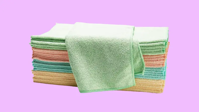 A set of colorful dish rags on a purple background.