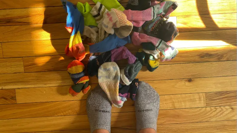 Pile of socks on wood floor.