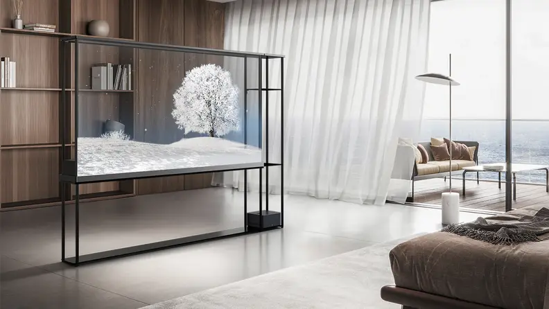 The 77-inch OLED T transparent TV in a posh bedroom setting, its transparency enabled, revealing a wall behind it