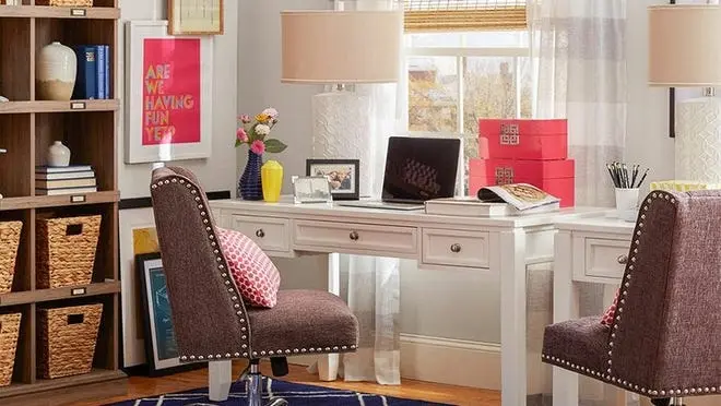 White desk in an organized office with pink accents.