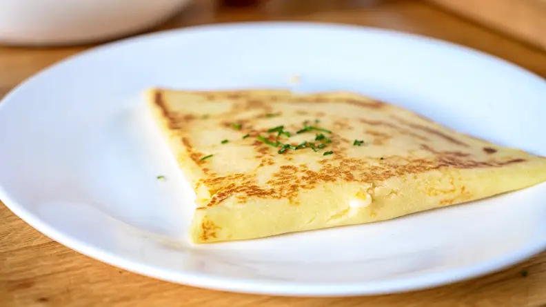 A savory crepe with ham and cheese.