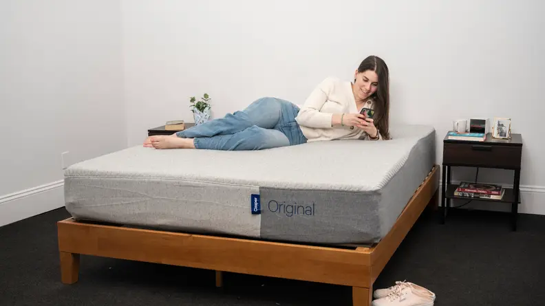 a person sits on the casper original mattress