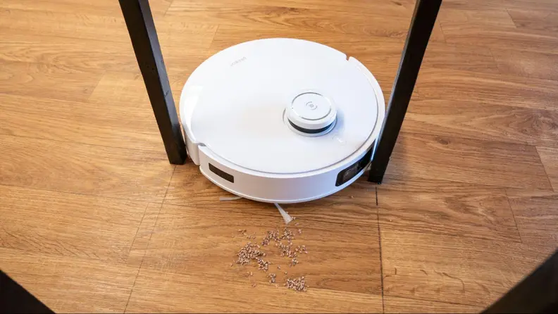 The T10 Omni cleaning between furniture legs.