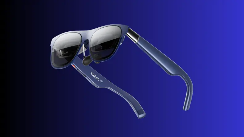 A pair of XREAL smart glasses is shown against a blue gradient background, highlighting the sleek frame and built-in display technology unveiled at CES 2026.