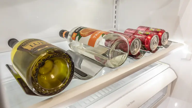 This fridge includes two caddies that can hole wine and liquor bottles, as well as cans.