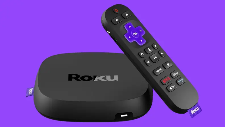 A Roku streaming device and voice remote displayed against a purple background. The compact Roku media player sits beside a black remote featuring shortcut buttons for popular streaming services, illustrating a simple and affordable way to access movies, TV shows, live channels, and streaming apps on a television.