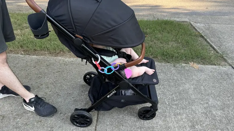 Baby in the Bombi Bebee stroller with the canopy down
