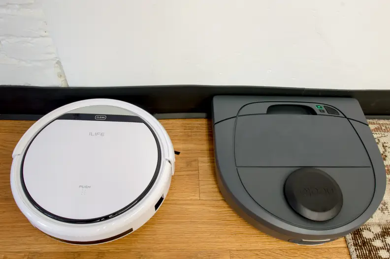 Unlike other robot vacuums, the Neato D3 (right) has a D-shape that allows it to get right against walls and baseboards.