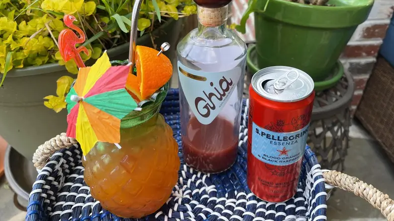 An assortment of mocktail ingredients arranged on a patio table.
