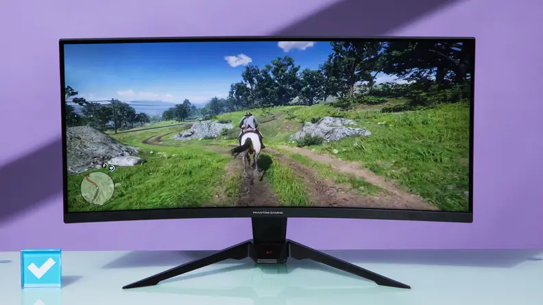 Front photo of the ASRock Phantom Gaming PG34WQ15R2B showing a cowboy riding a horse on its screen.