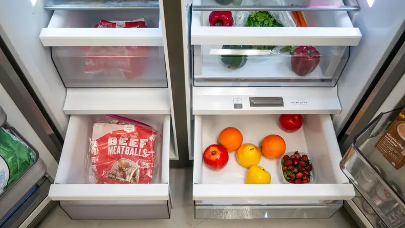 Crisper drawers with fruits and vegetables inside of the Midea MRS26D5AST Side-by-Side Refrigerator.