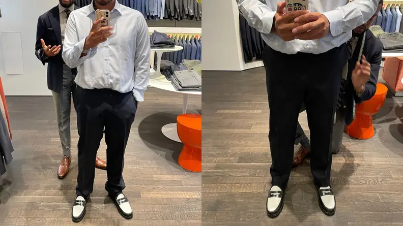 Inside of Tampa Suitsupply with a man helping with a suit fitting.