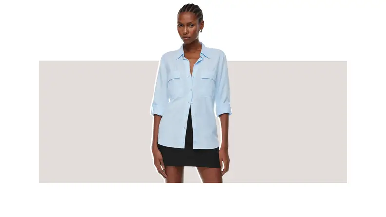 A model wearing a blue button-up dress shirt.