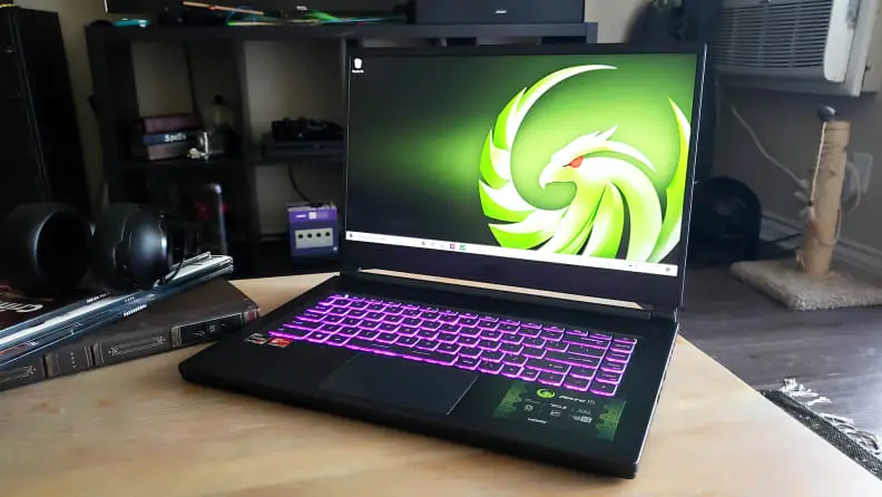 An open and powered on laptop sitting on a coffee table in a livingr oom