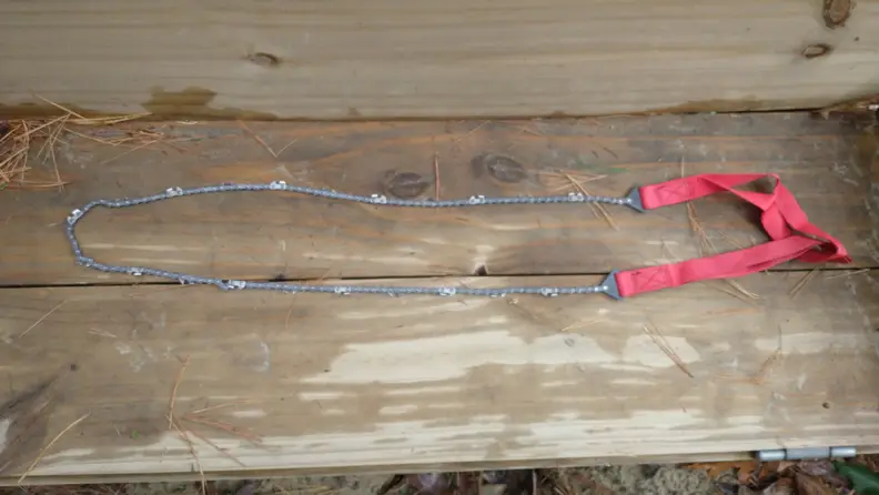 Pocket chainsaw on wooden surface.
