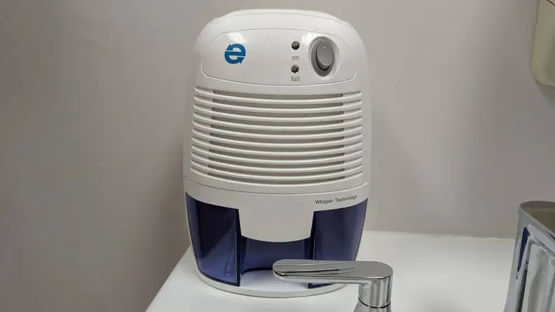 The Eva-Dry EDV-1100 small dehumidifier placed on a bathroom sink to reduce humidity in a small bathroom.