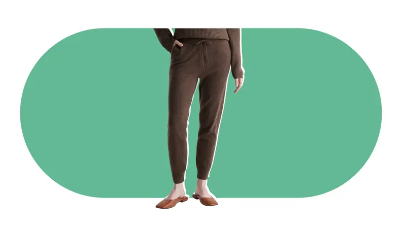 A model wearing brown cashmere sweatpants.