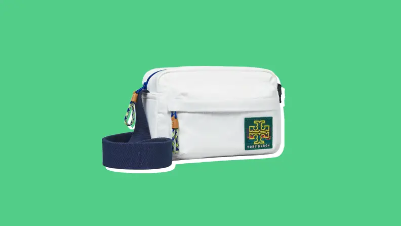 Photo of the Tory Burch Ripstop Crossbody Bag against a green background.