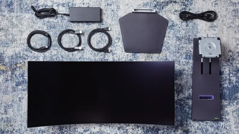 The LG UltraGear OLED 34GS95QE-B disassembled, showing the screen, cables, and power brick
