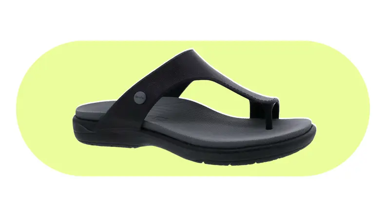 Dansko Krystal sandal on a yellow background.