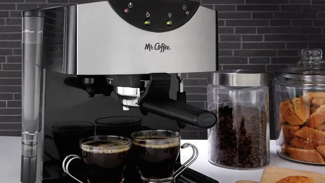 Mr. Coffee silver espresso maker filling up two espresso cups