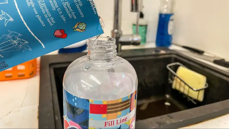 Cleaning concentrates poured into a spray bottle.