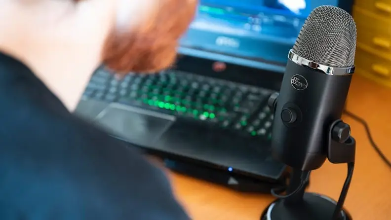 A person speaks into a microphone.