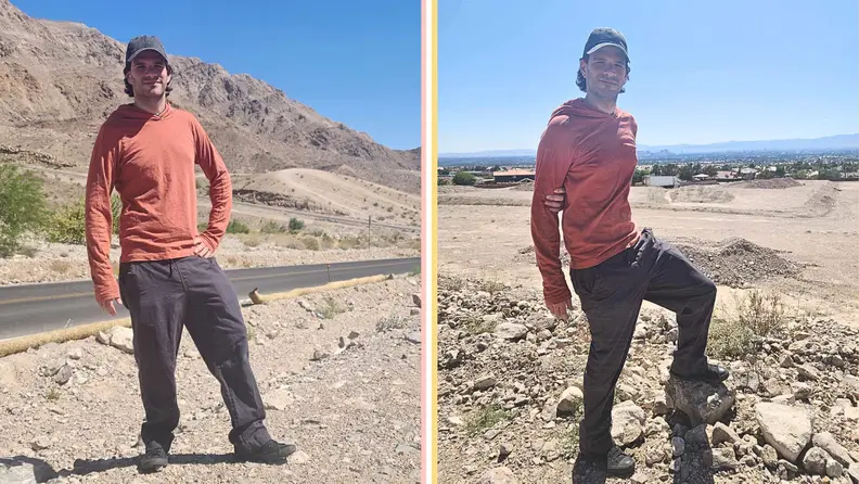A man modeling the hooded tee with a desert backdrop.