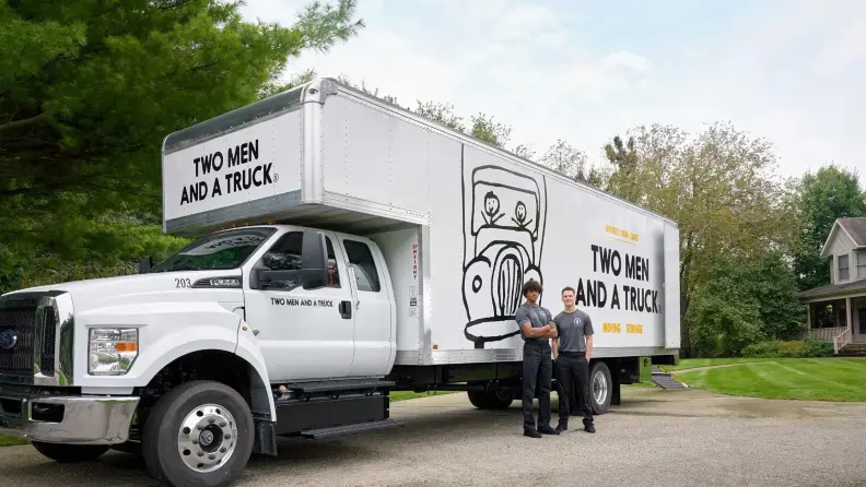 Two movers and a white truck behind them