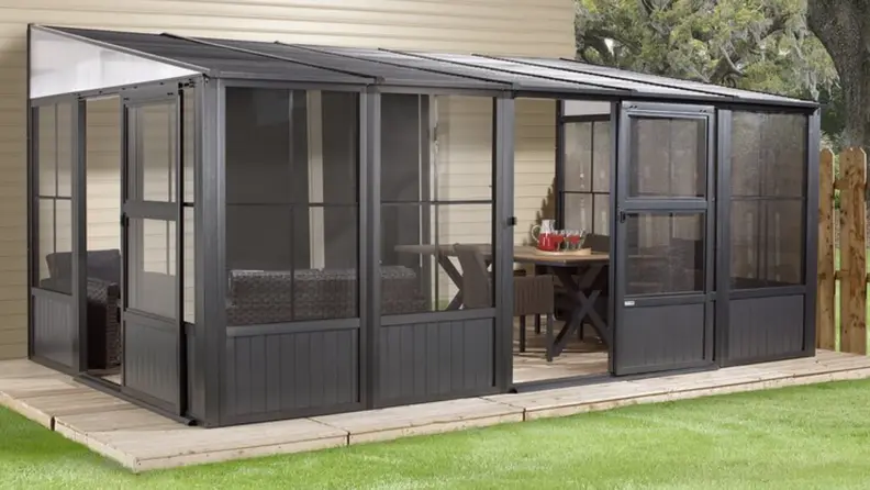 Metal patio enclosure in a backyard
