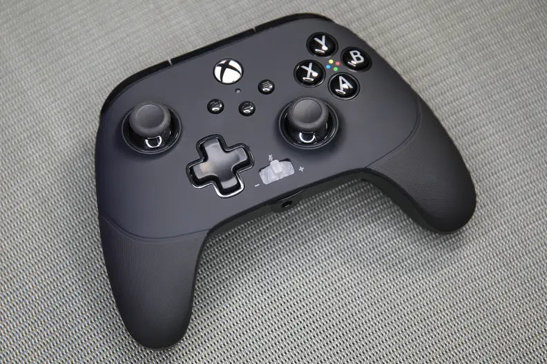 A black controller on a carpet