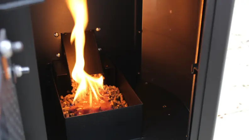 The interior of the Solo Stove Patio Heater with the wood pellets lit on fire.
